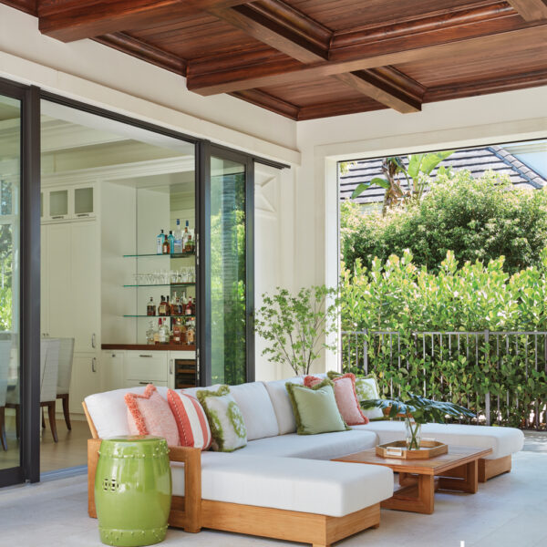 A Breezy Lanai Makes It Easy To Embrace Year-Round Sunshine outdoor living area with teak RH sectional and citrus pillows