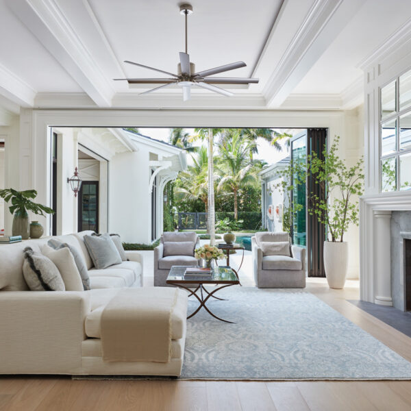 A Breezy Lanai Makes It Easy To Embrace Year-Round Sunshine living room with Lee Jofa sofa and armchairs and wool rug