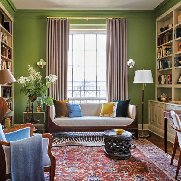 A Spunky Color Story Elevates A PreWar Duplex With Old New York Charm green library with midcentury modern furniture