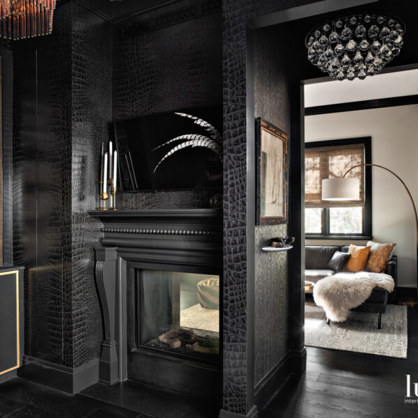 Deep Tones And Moody Wallpaper Add Drama To A Renovated Oregon Bungalow black carved fireplace surround with west elm black sectional