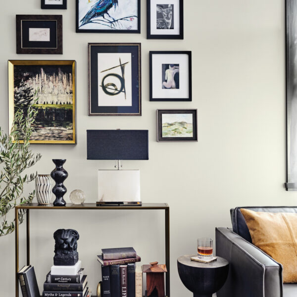 Deep Tones And Moody Wallpaper Add Drama To A Renovated Oregon Bungalow black and gold gallery wall above console table