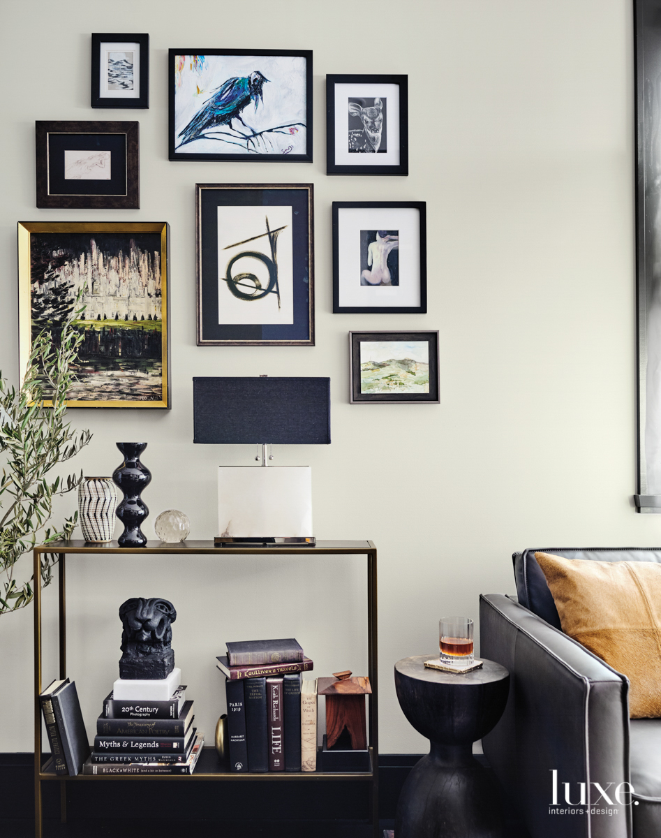 black and gold gallery wall above console table