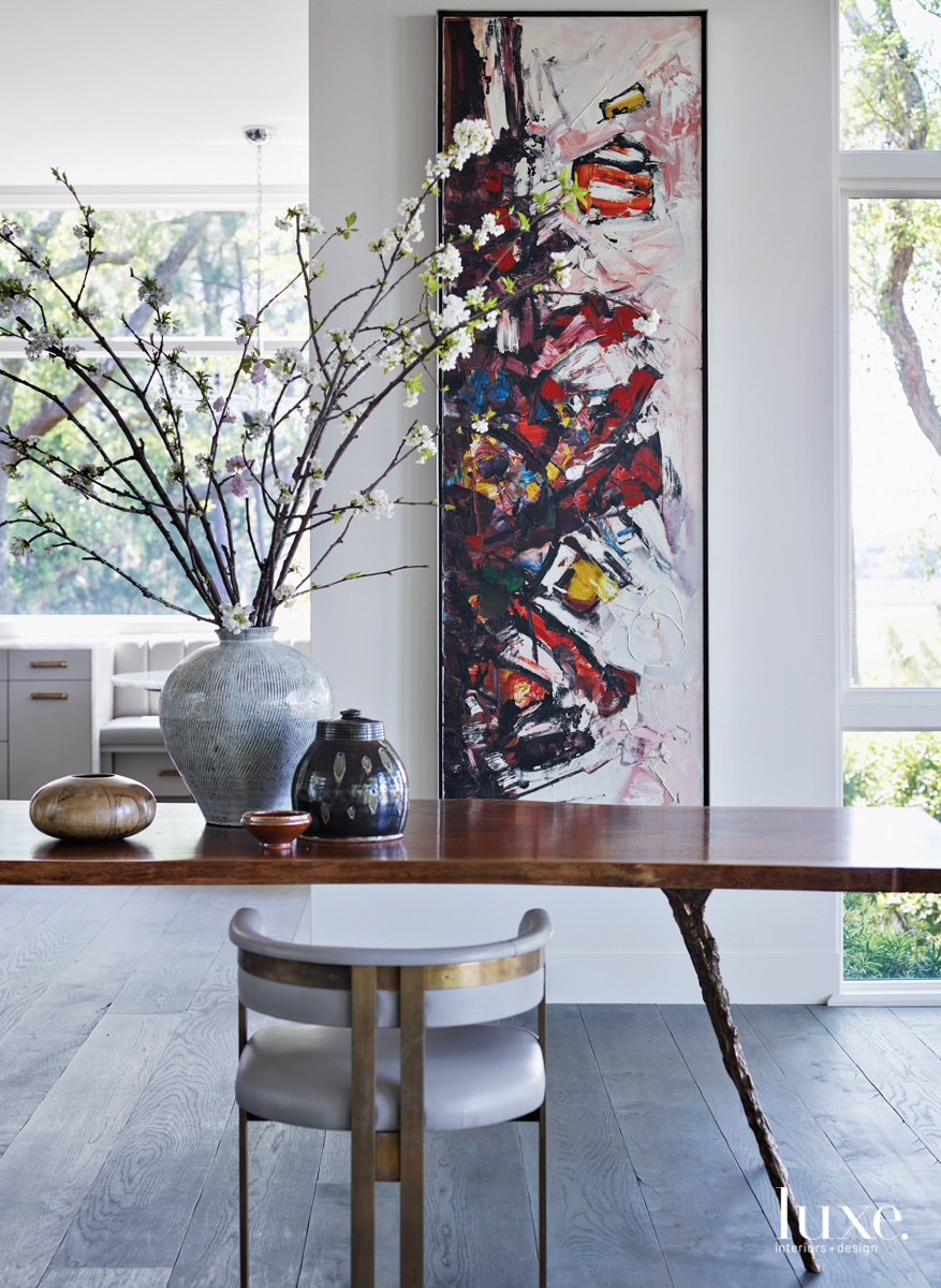 living room with tree slab dining table and abstract art