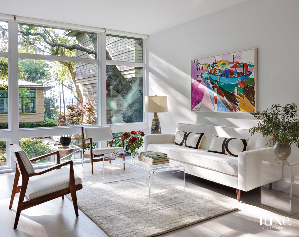 living room with midcentury sofa and armchairs and jason berger painting