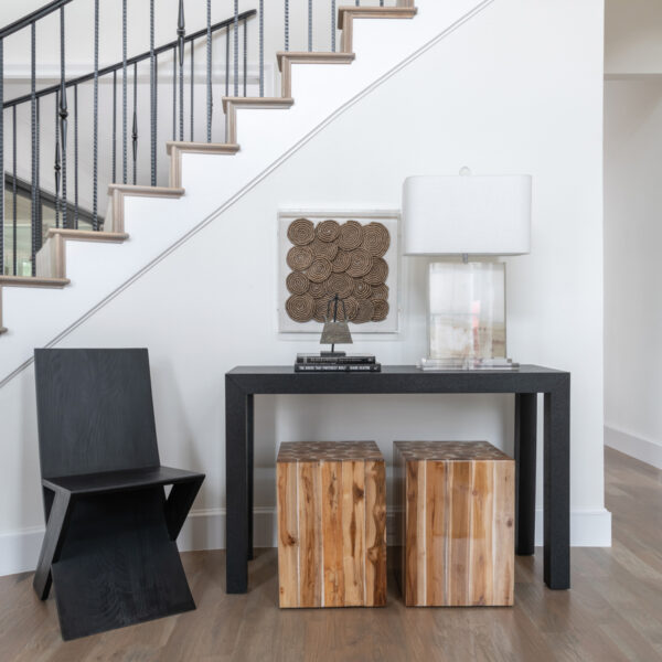 Architectural Wow-Factors Keep A Dallas Home Family-Friendly black console table and chair by staircase