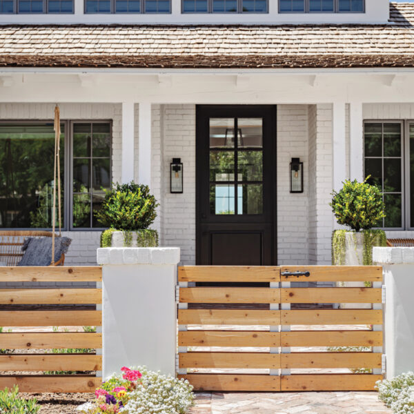 Never Underestimate The Power Of Comfort. Inside A Modern AZ Farmhouse With Beachy Accents. front door exterior with swinging chair and barn doors for a gate