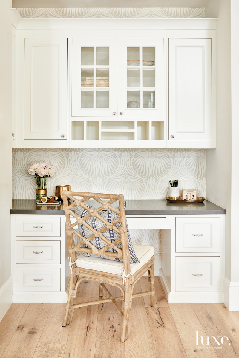 Wallpaper adds a layer of interest to the desk nook in the kitchen.