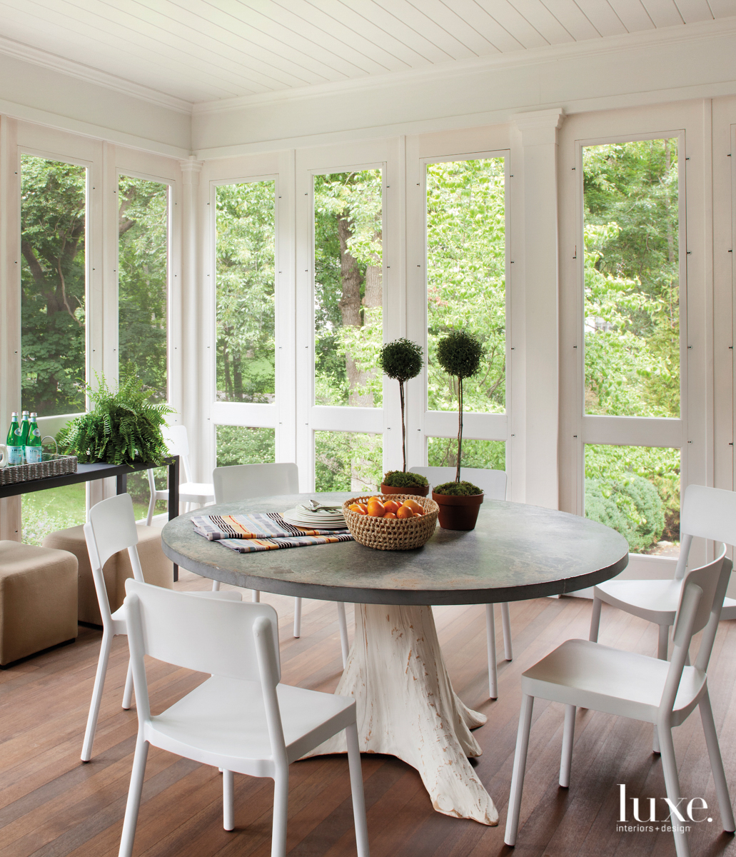 white dining space that has windows open to scenic views