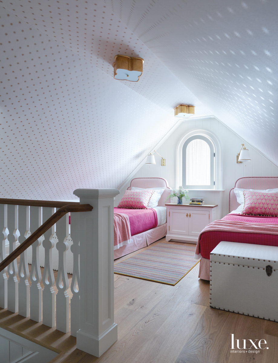 The loft of the girls' room, which has pink and white decor.