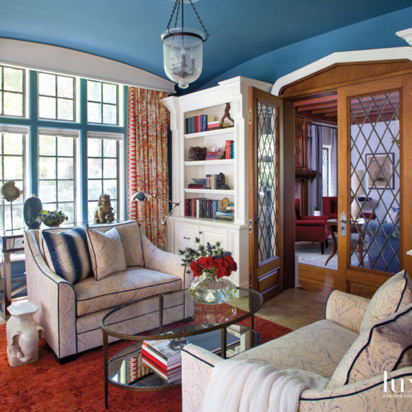 The Vibrant Denver Home With A Speakeasy Original To The 1928 Traditional Tudor A sitting room has a pair of loveseats facing each other.