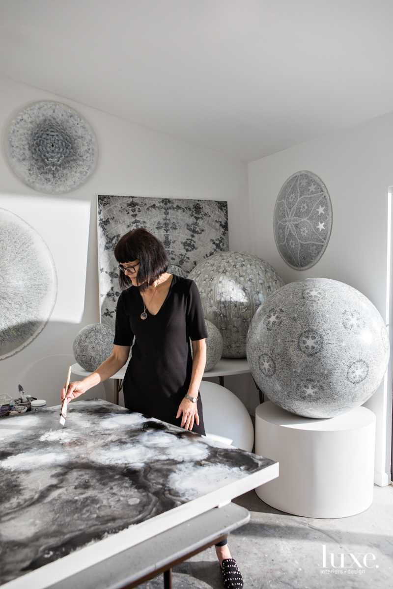 carol prusa in her studio surrounded by cosmic pieces