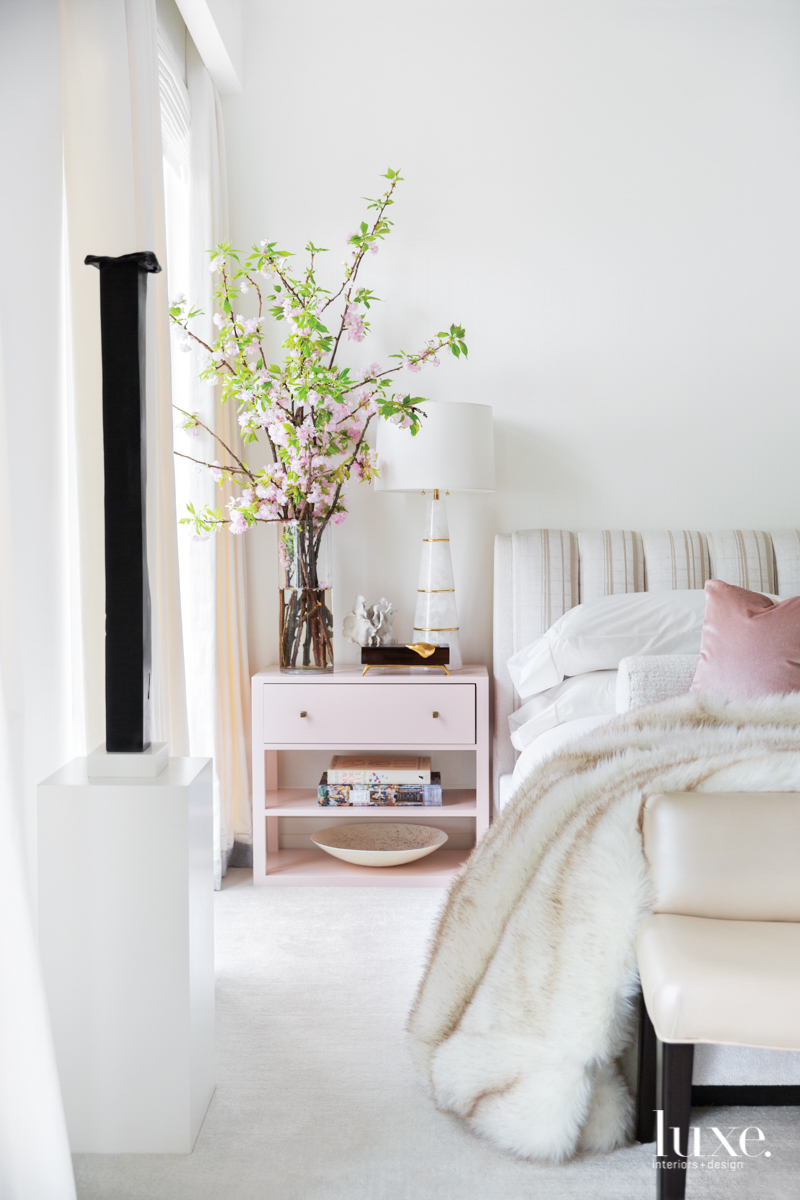 white bedroom with pink side...