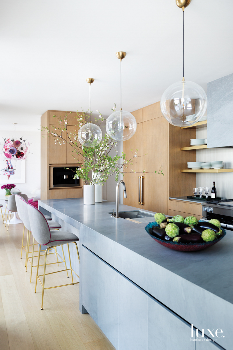 minimalist modern gray and light wood kitchen with globe pendants