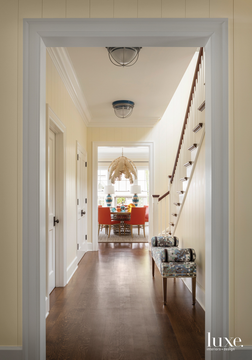 A long hallway leads to a dining room.