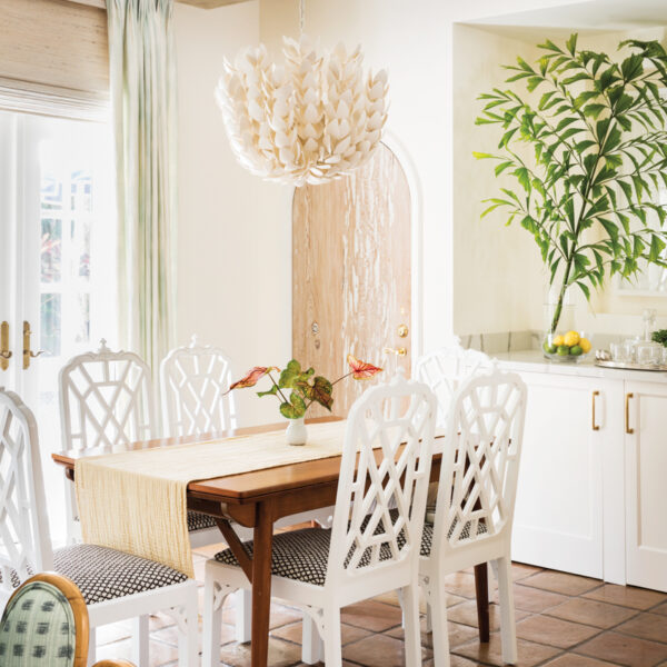 Ties To An Iconic Palm Beach Hotel Inspire An Equally Chic Villa All About Simple Luxury dining area with pendant, white chairs a teak table and terra-cotta flooring