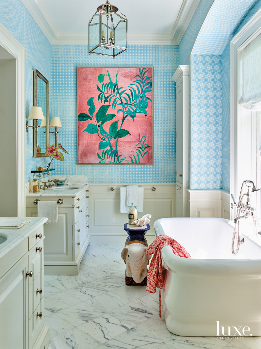 bedroom with light blue wallcovering and bright pink tropical artwork