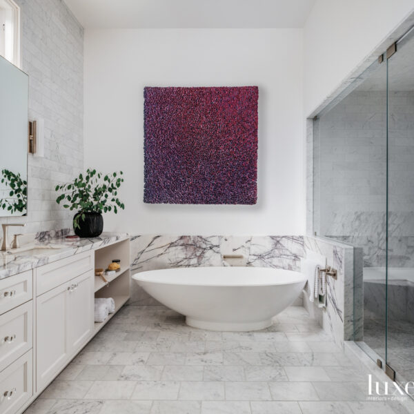 The SF Grand Victorian That Proves Honoring History Still Saves Room For Plenty Of Personality bathroom with stand alone tub and pink and purple art above bath