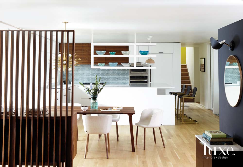 modern kitchen with aqua tile, white cabinets and glass sculpture on floating shelves