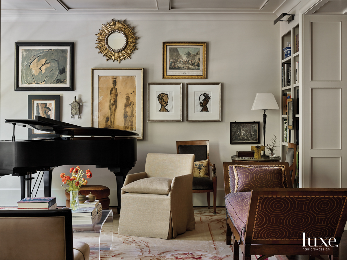 living room filled with art, antiques and a baby grand piano