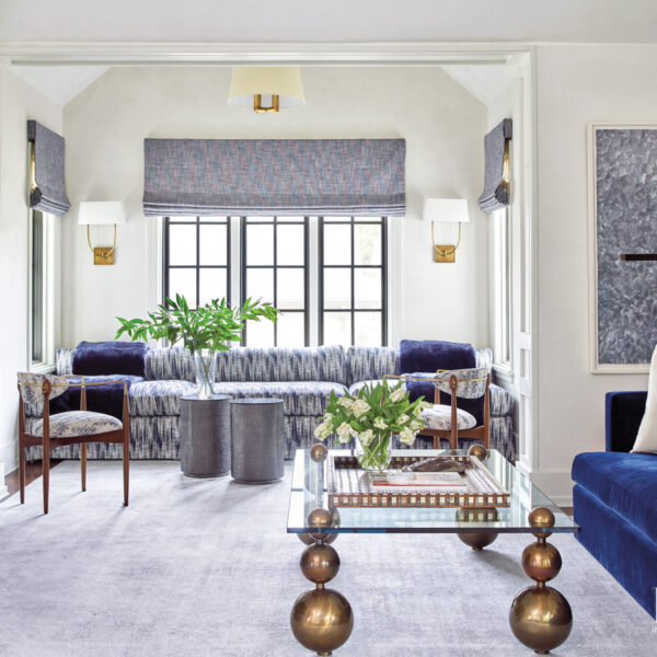 Who Can Resist That Charming London Look? A Houston Home Embraces Those City Chic Vibes media room with a wall-to-wall and a custom banquette sectional