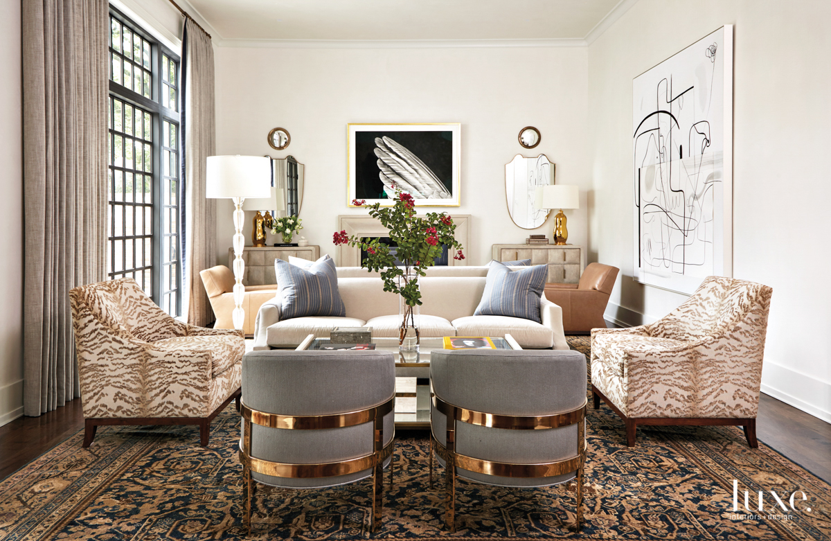 family room with frame chairs, armchairs and art