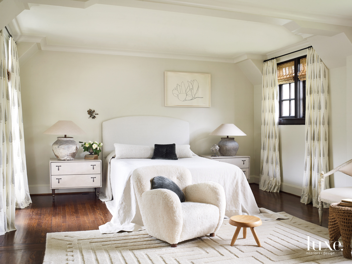 Master bedroom featuring textural furnishings and wall art hung in an unexpected spot