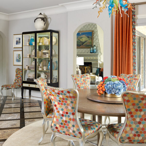 Orange fabric window curtains and multi fabric dining chairs
