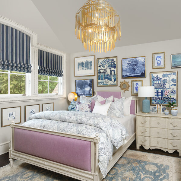 Girls bedroom with pink and wood framed bed with chandelier and blue accents