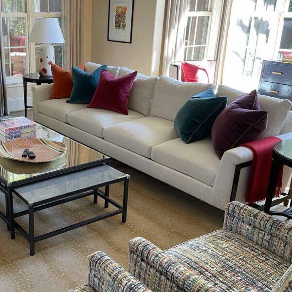 A white couch with colorful accent pillows
