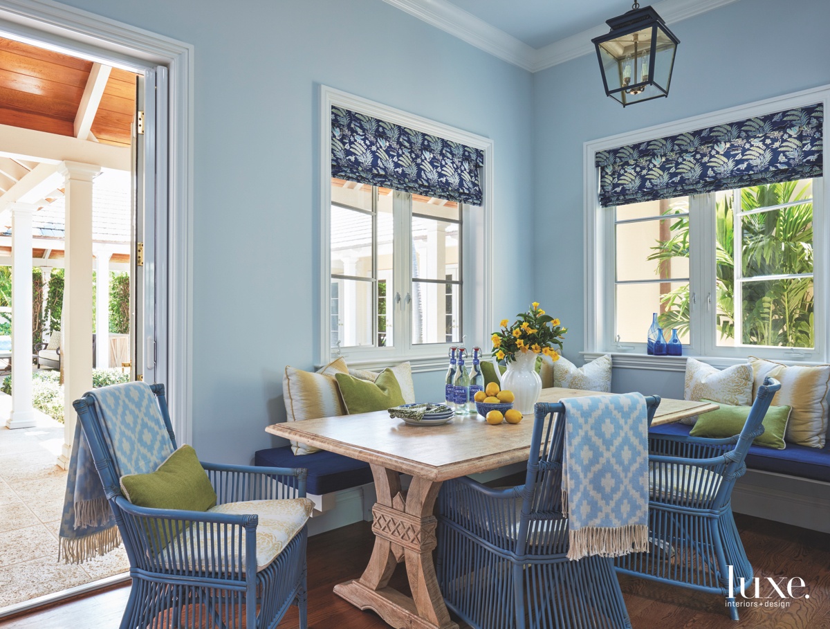 blue breakfast nook with blue chairs, linens and stone table