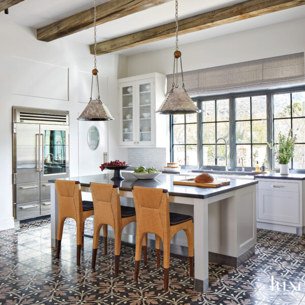 A Stunning Mountain Backdrop Elevates The Luxe Factor Of This Mediterranean-Style Arizona Villa A bright Mediterranean style kitchen with an island and patterned tile flooring