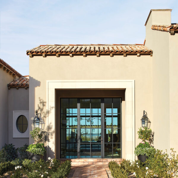 A Stunning Mountain Backdrop Elevates The Luxe Factor Of This Mediterranean-Style Arizona Villa Landscaping frames the entrance to this Mediterranean-style home