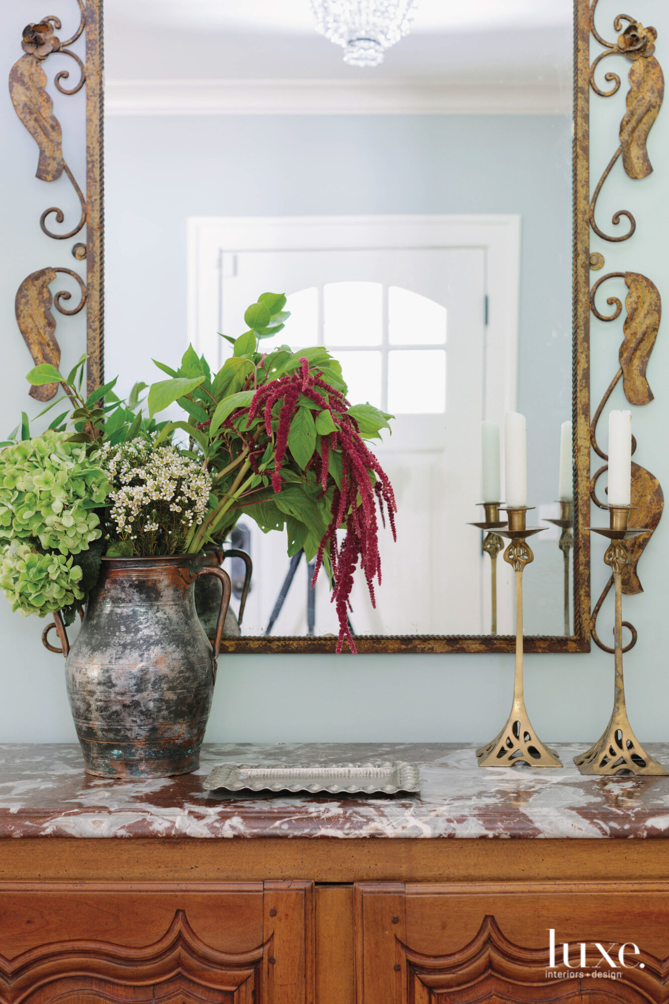 Antiques can be found all over the home, including in this vase, the mirror and candleholders