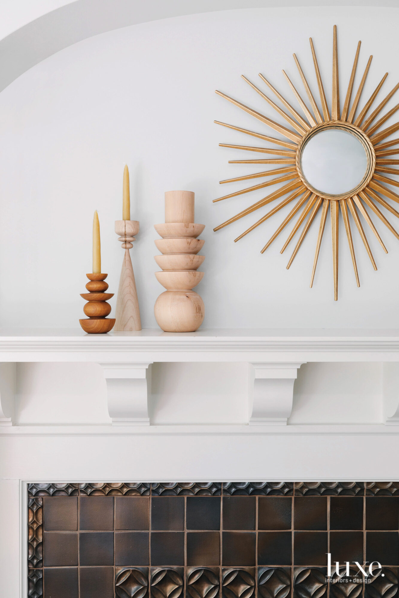 Whimsical decor pieces sit on a mantel above the fireplace