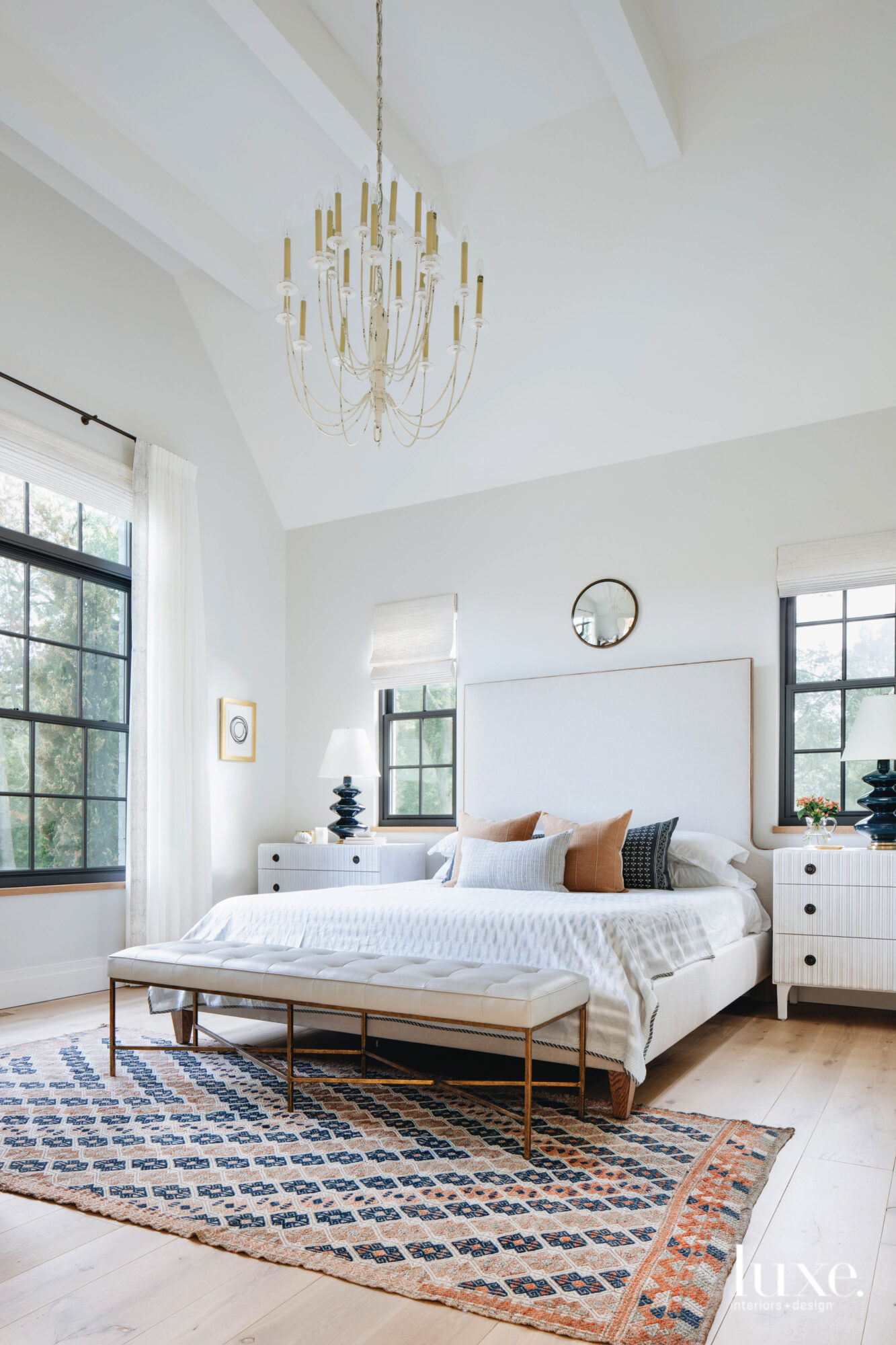 Soft neutrals dominate the master bedroom, with pops of camel and navy for punctuation.