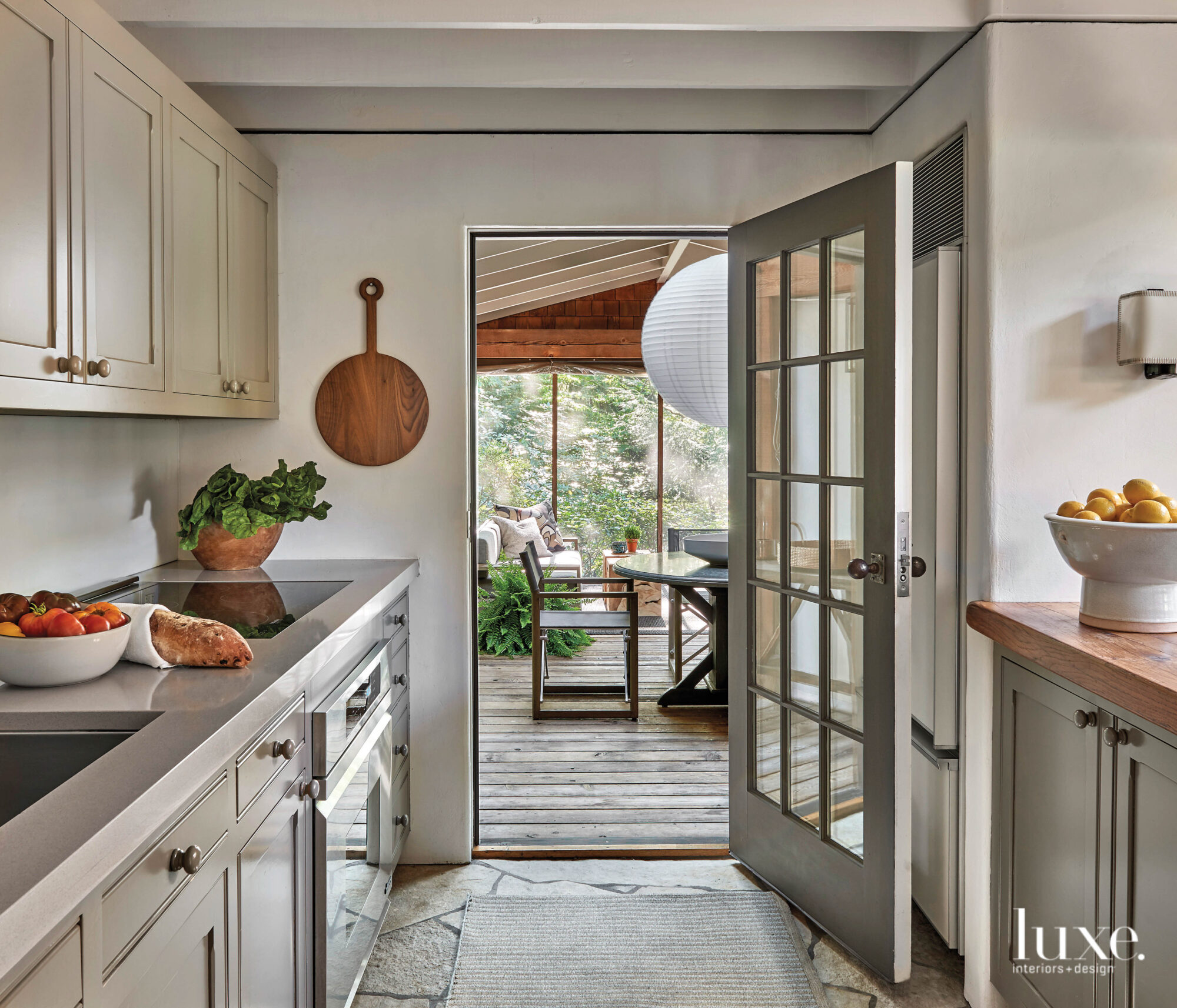 A gray, updated kitchen stands out from the rest of the cabin-like home.