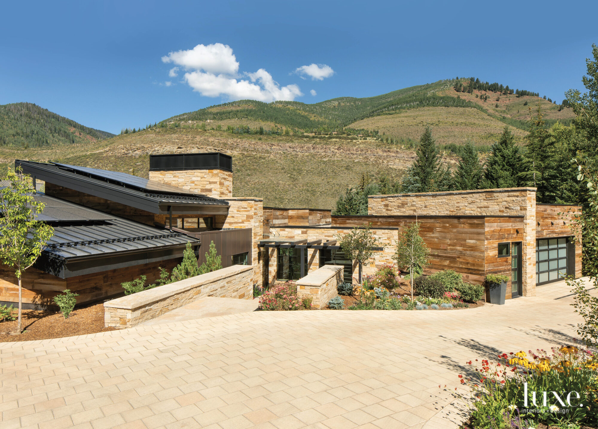 A large stone home sits in the mountains of Vail.