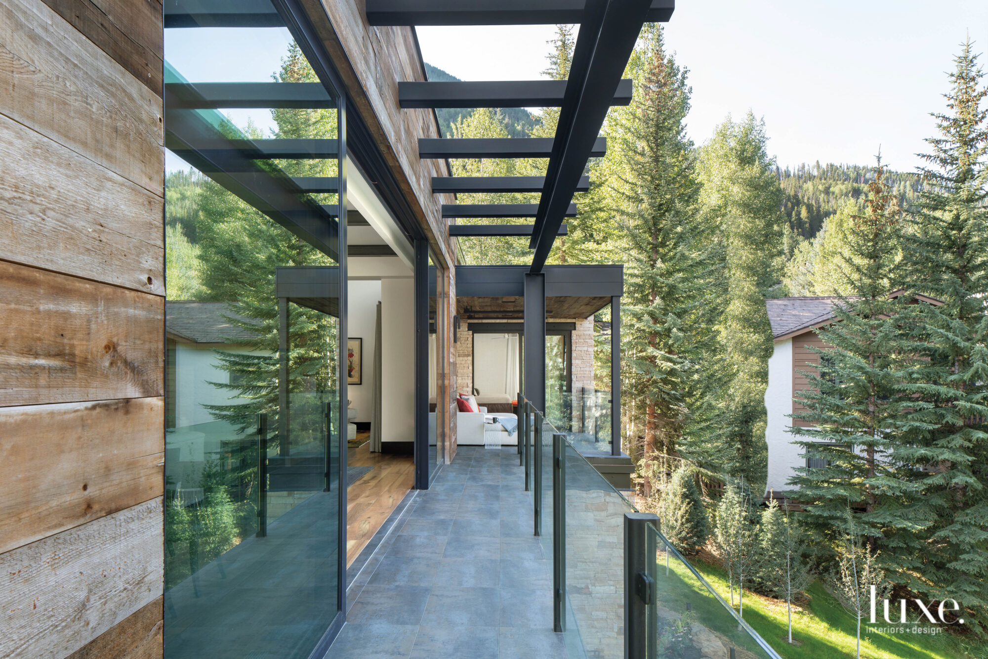 Large glass doors open onto a stone-tiled deck.