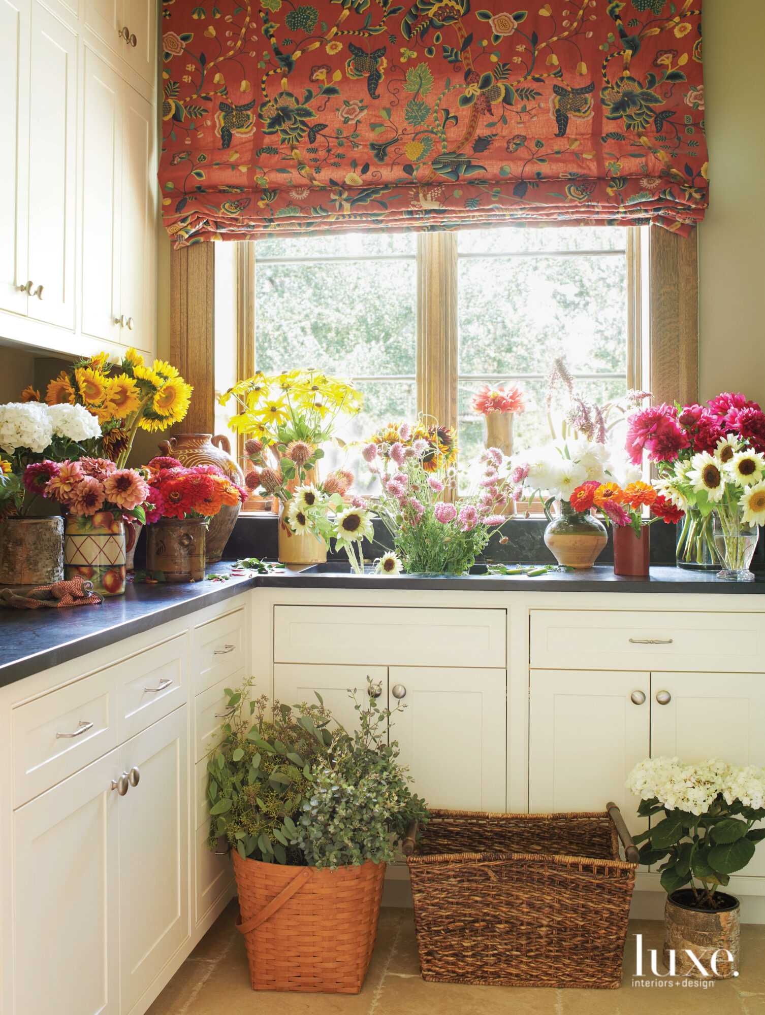 A flower arranging and cutting room is laden with blossoms.