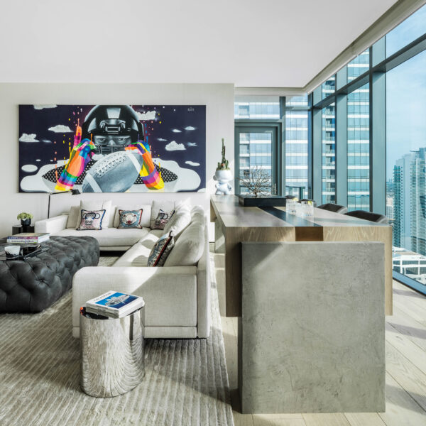 High In The Sky Yet Down To Earth, This Miami Renovation Offers The Best Of Both Worlds A media room with artwork depicting a football player.