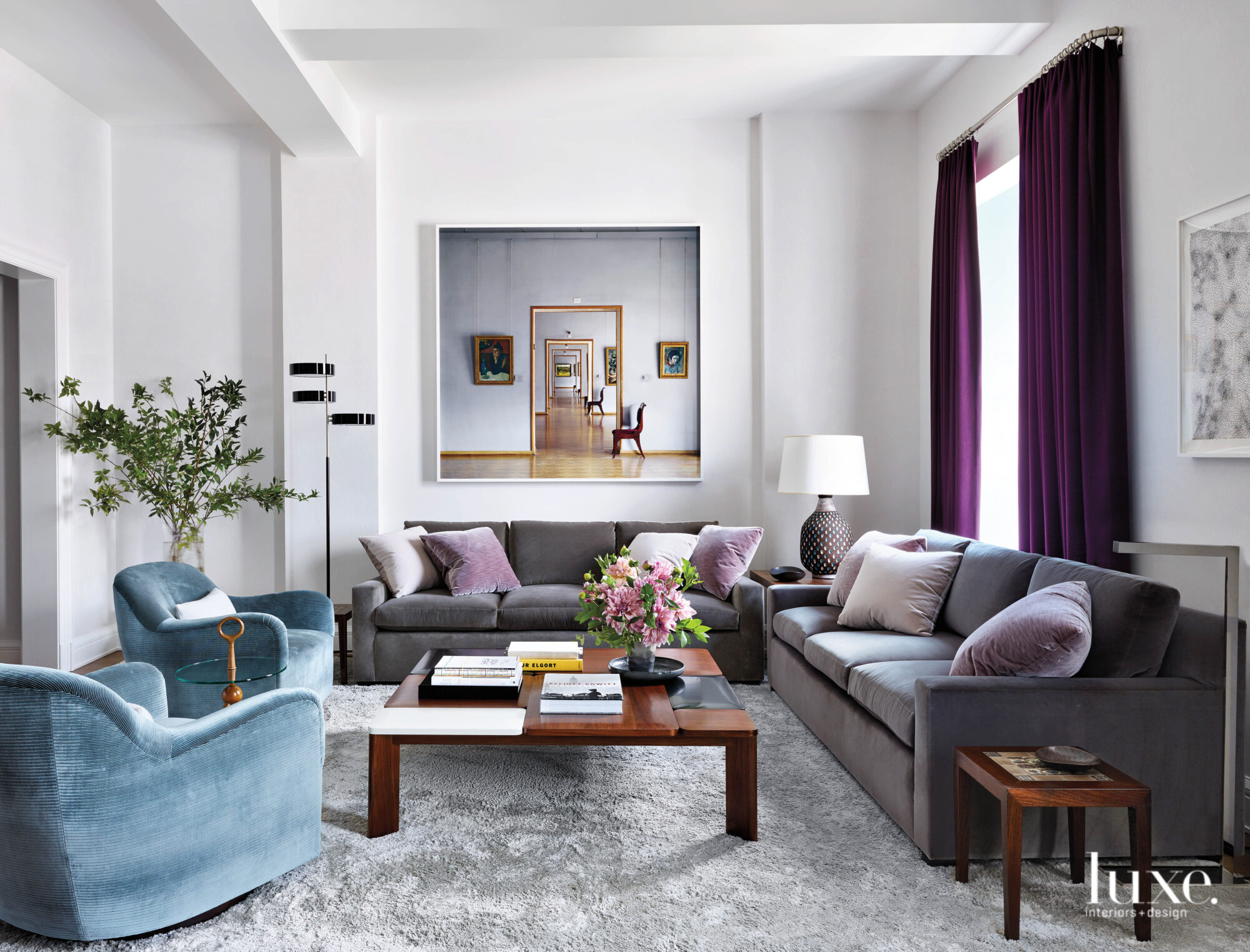 Cool colors are scattered throughout a plentiful living space that's atop a soft area rug