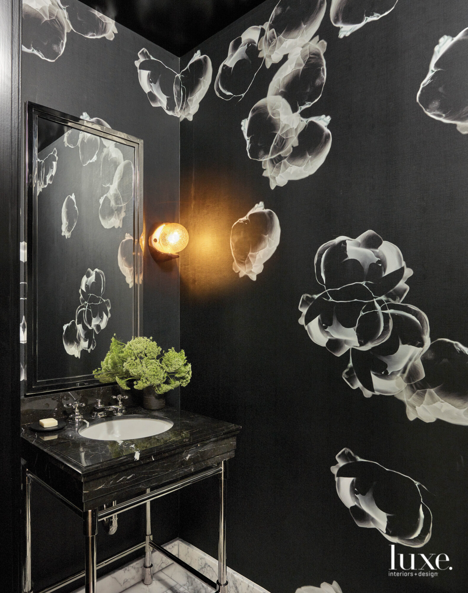 A black and white floral wallpaper covers the dark, moody yet sophisticated bathroom