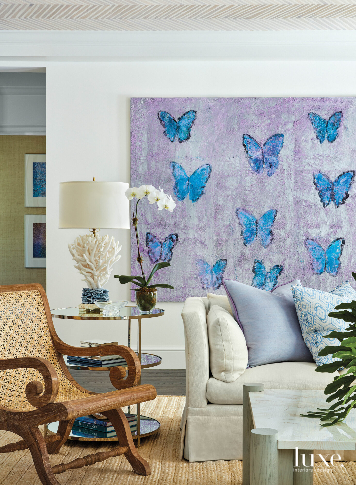 Living area with blue and purple butterfly artwork on wall.
