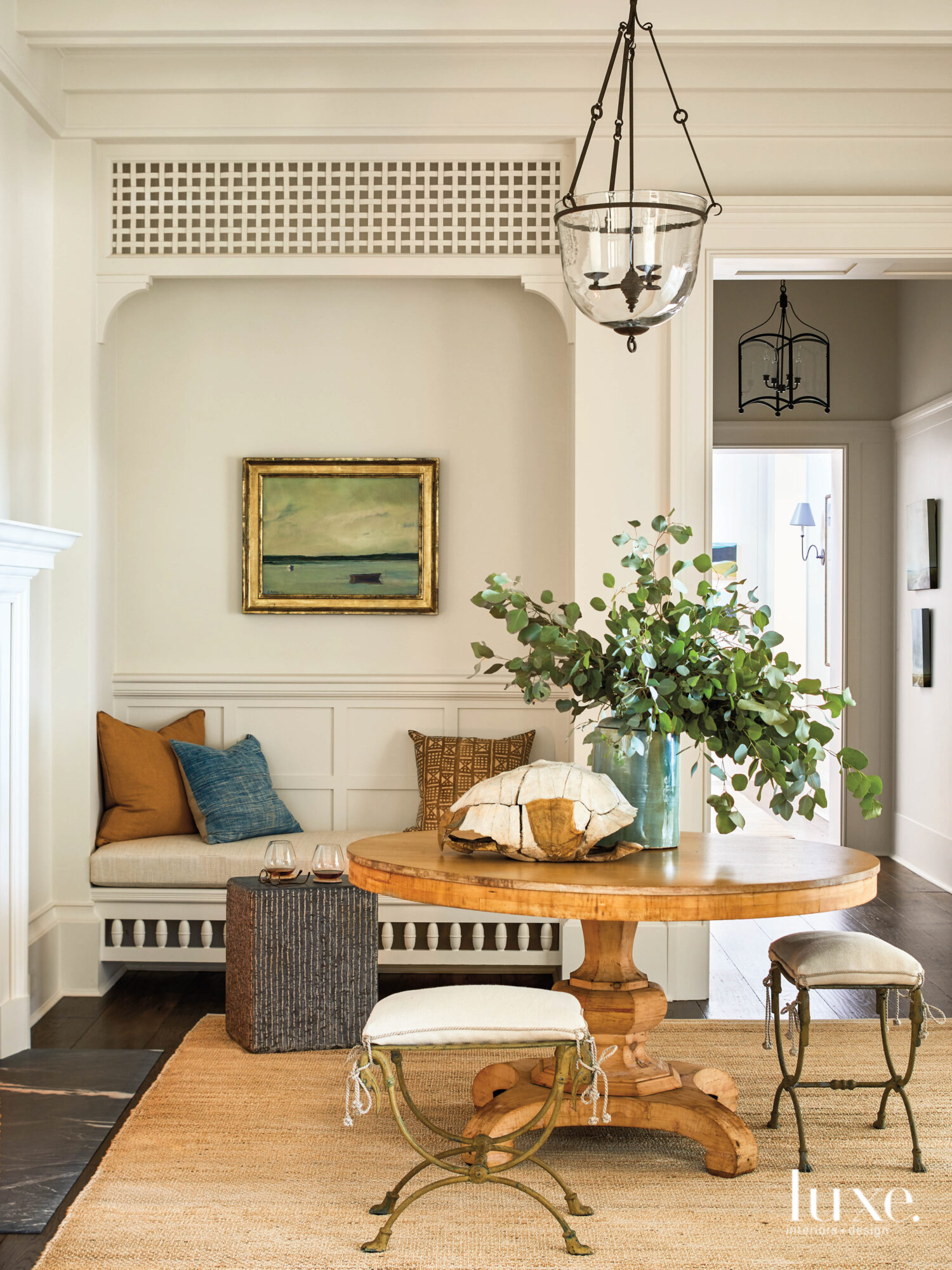 Entryway with round table, bell jar pendant and inglenook
