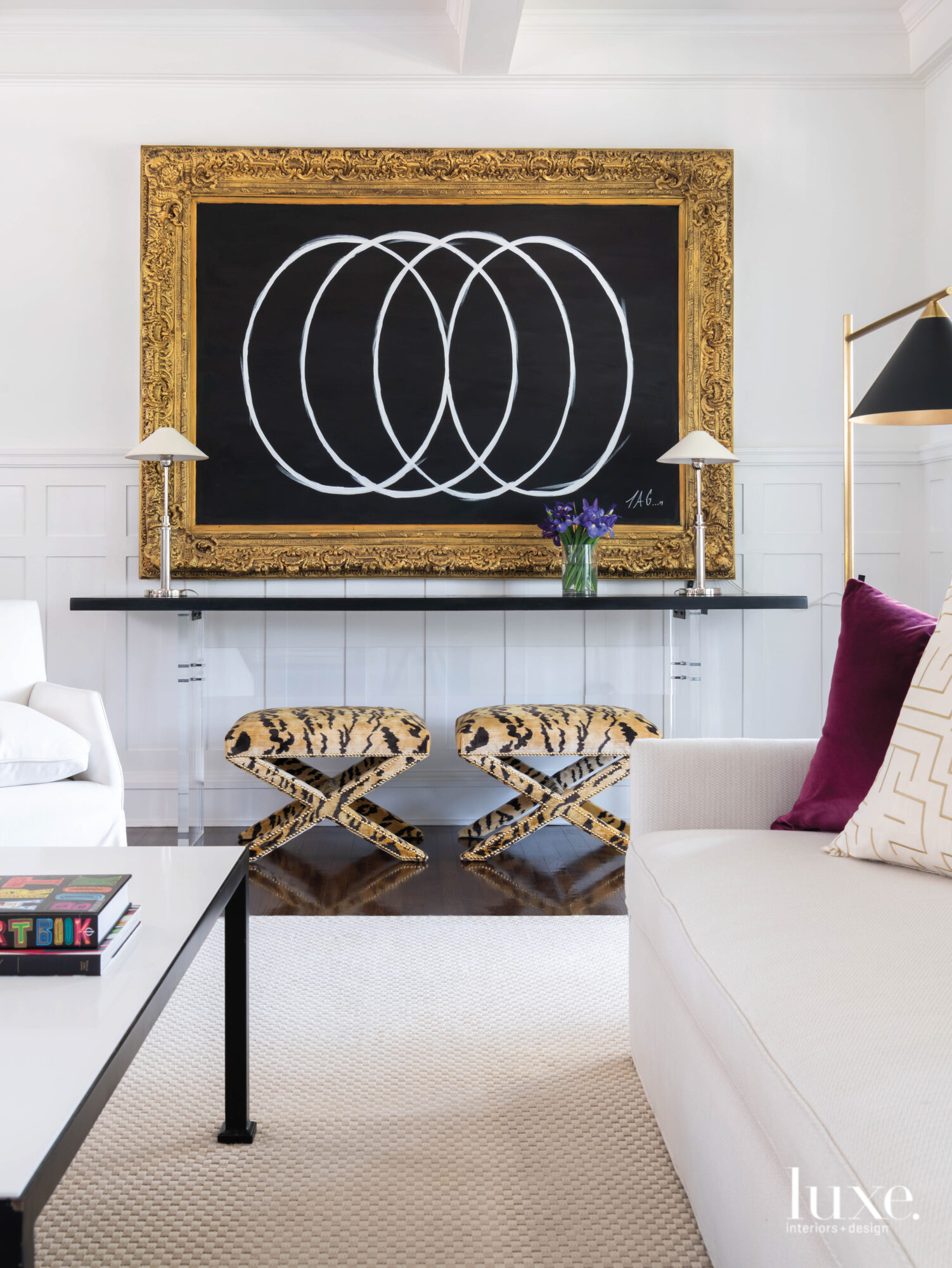 A black art vignette spices up the nearly all-white living room