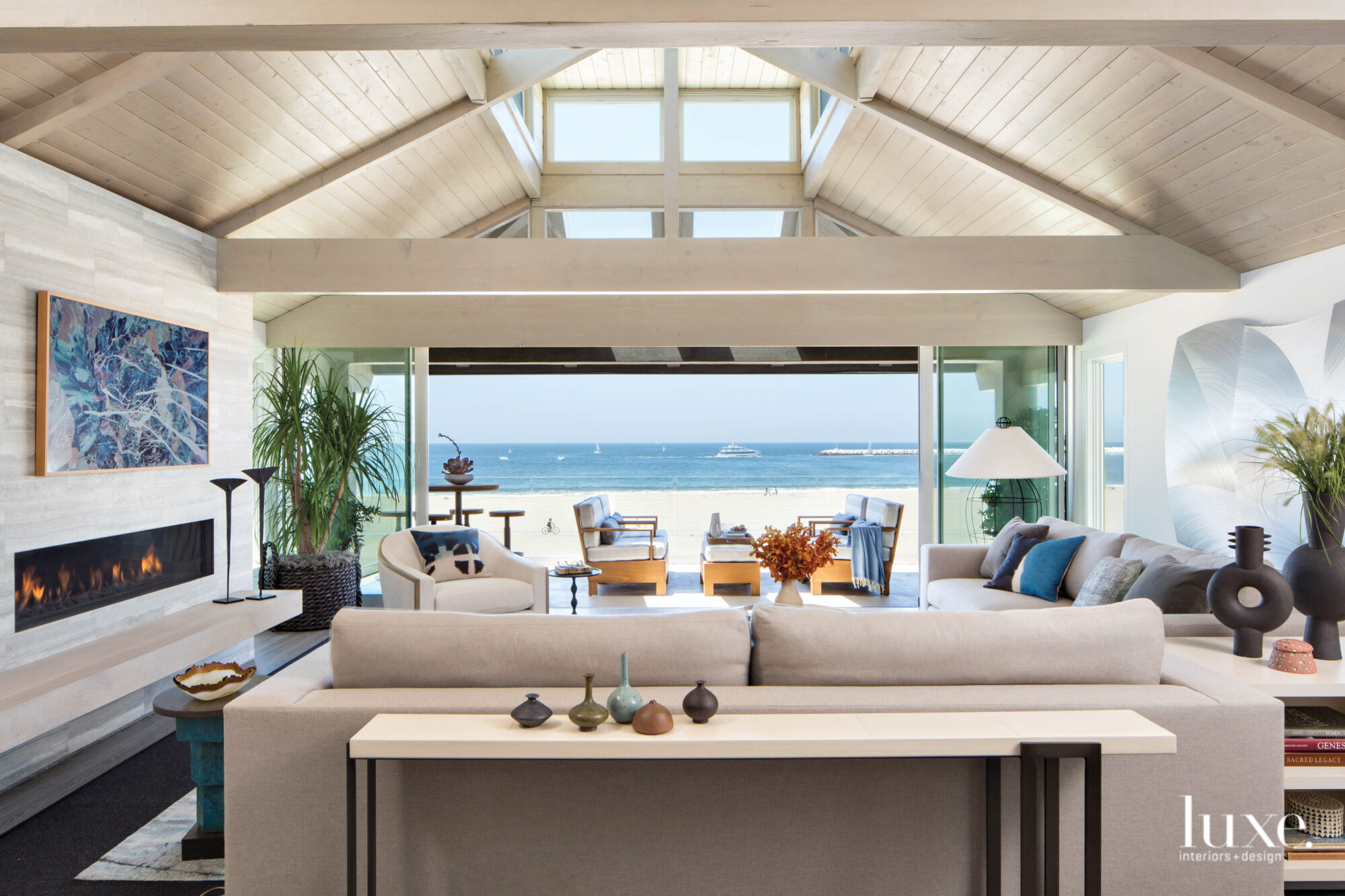 Living room with sofa looking out to outdoor seating and ocean
