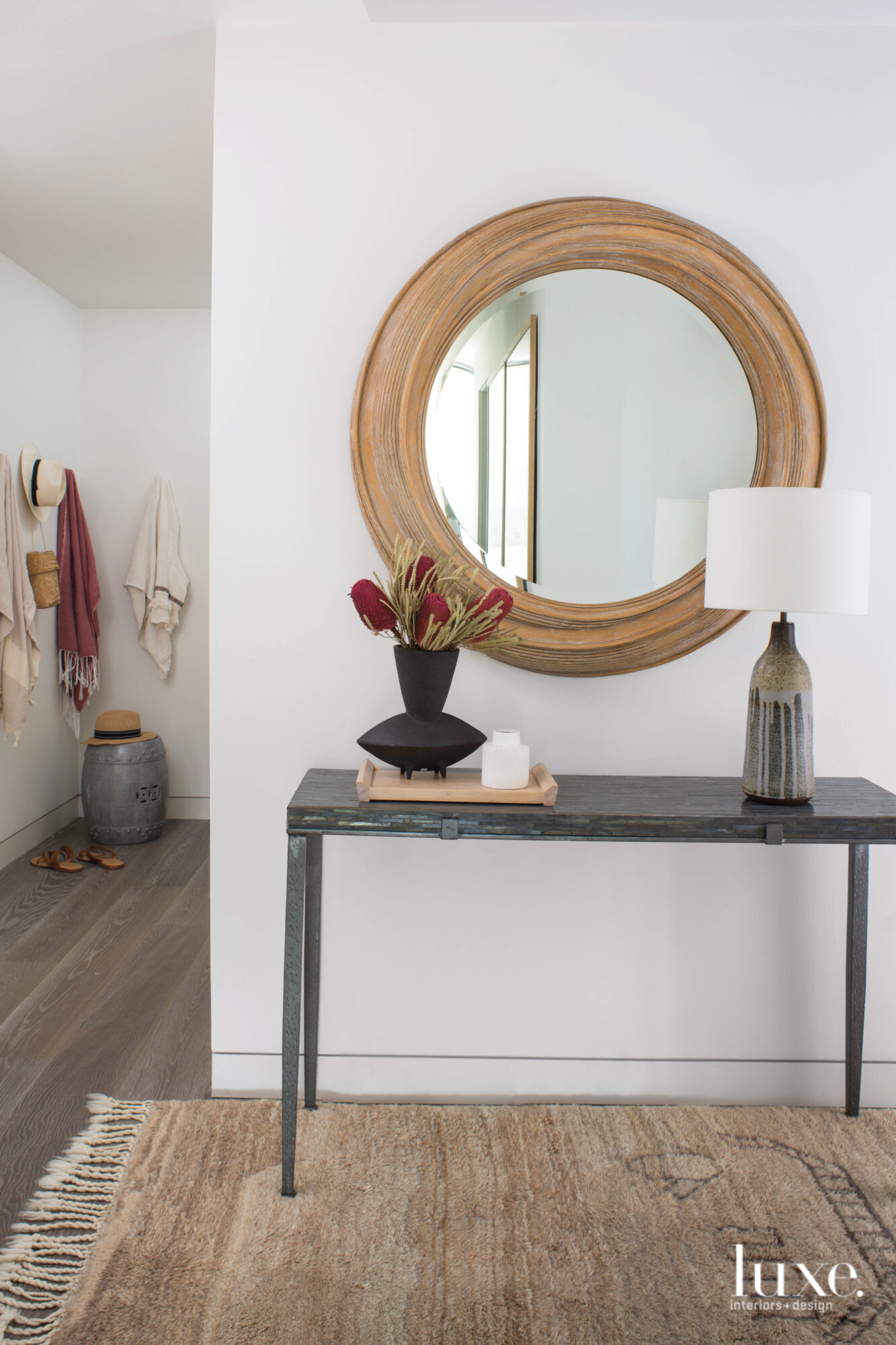 Detail of entry with a console table and mirror above.
