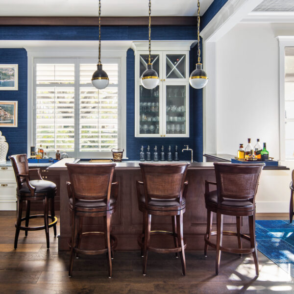 A Miami Reno With A Breezy Hamptons Vibe Offers Relaxed Style Bar and lounge with navy walls and dark wood bar with stools