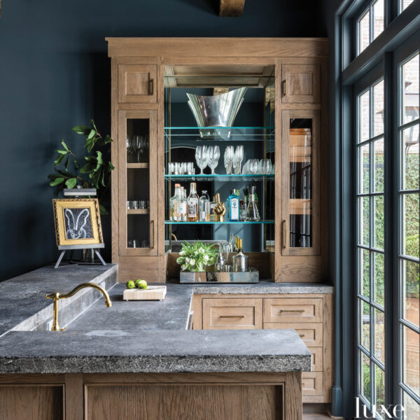 Renovating Their House Helps A Houston Family Feel Right At Home Custom bar area with blue walls and reclaimed countertops.
