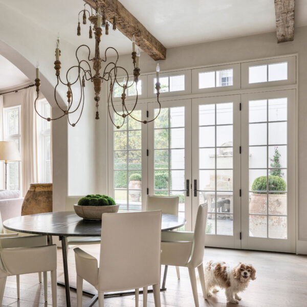 Renovating Their House Helps A Houston Family Feel Right At Home Light-filled breakfast area with neutral furnishings and a cute dog.